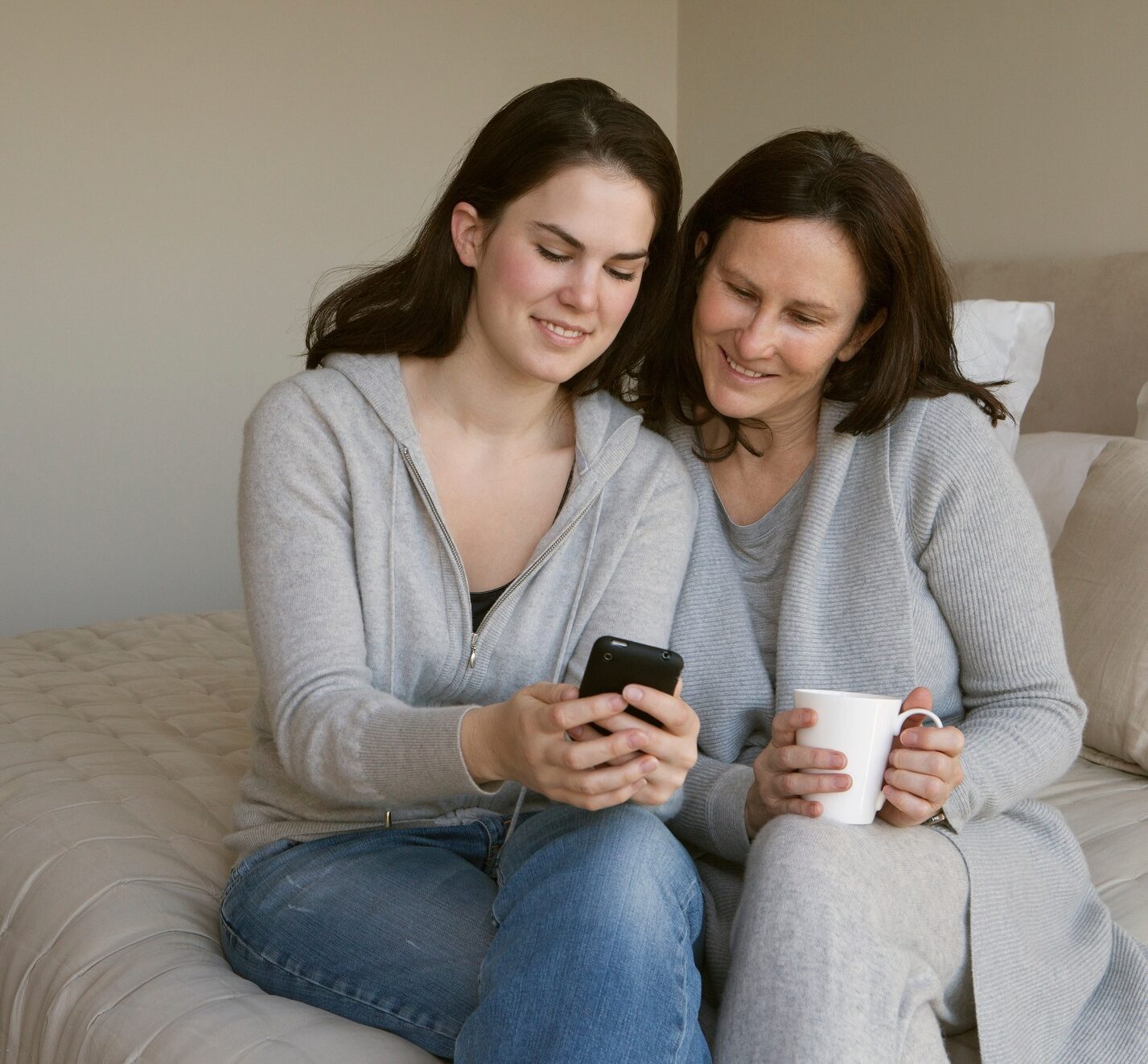 Mother and daughter looking at phone