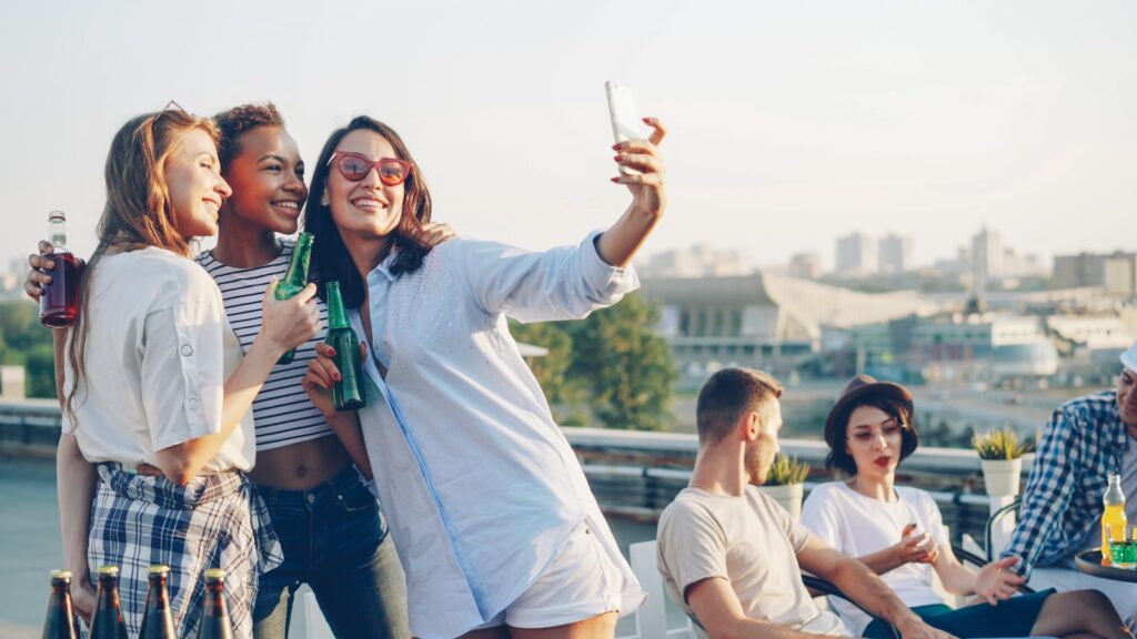 Friends taking a selfie at a rooftop party